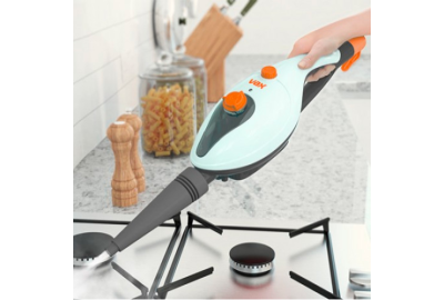 A person using a Vax steam cleaner to clean a hob in a kitchen area